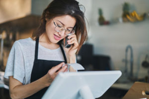 Woman prints receipt on clover pos system