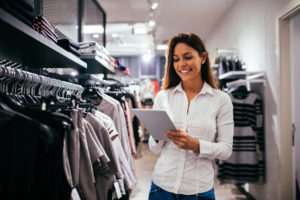 Retail shop manager doing inventory on tablet