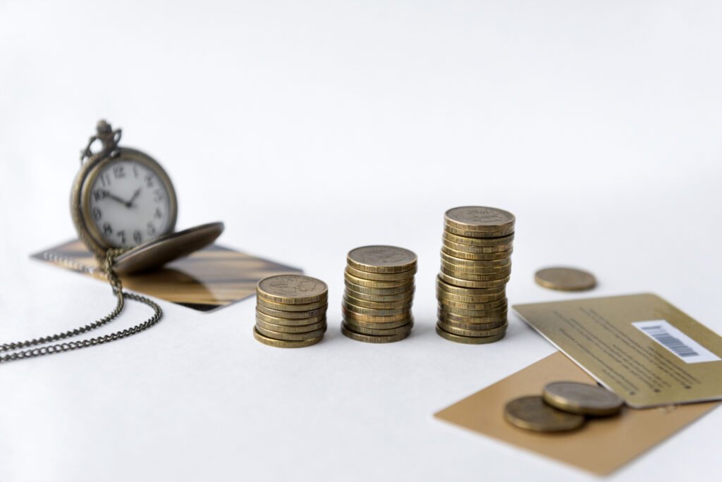 coins pocket watch on chain multiple bank cards on white background time money 137490281 1