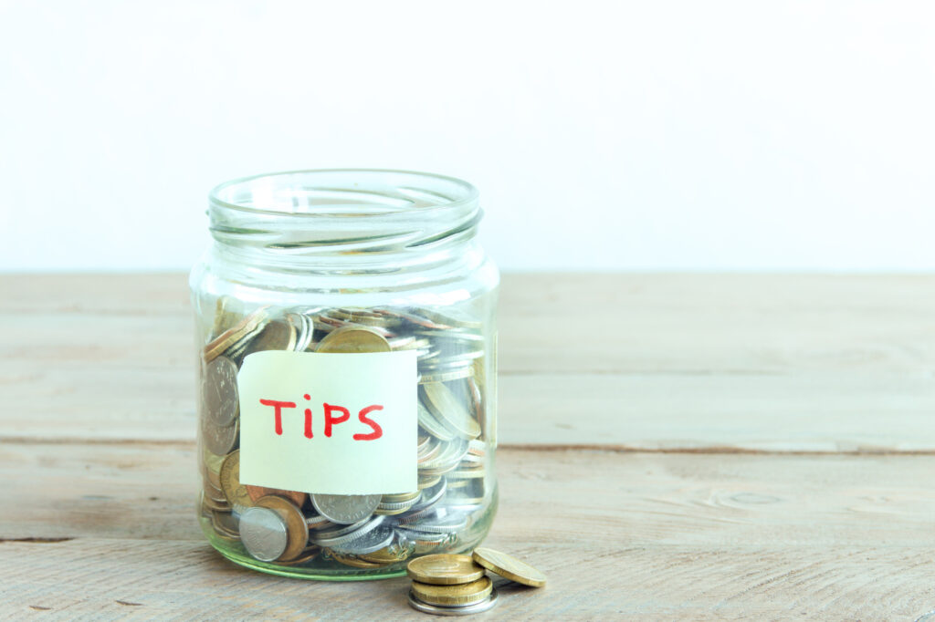 coins in jar with tips label 108581949