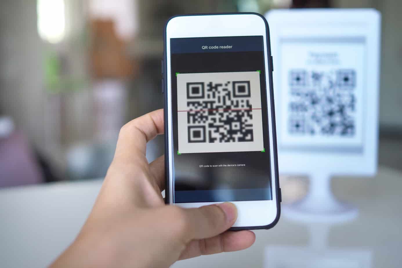 women hand uses a mobile phone application to scan qr codes in stores that accept digital payments without money and plastic 185122541
