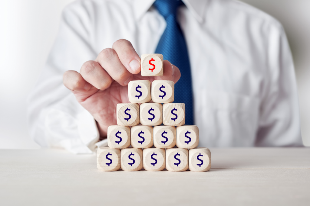 businessman placing a wooden cube with check percent or percentage symbol on top of tiered wooden cubes 218070076