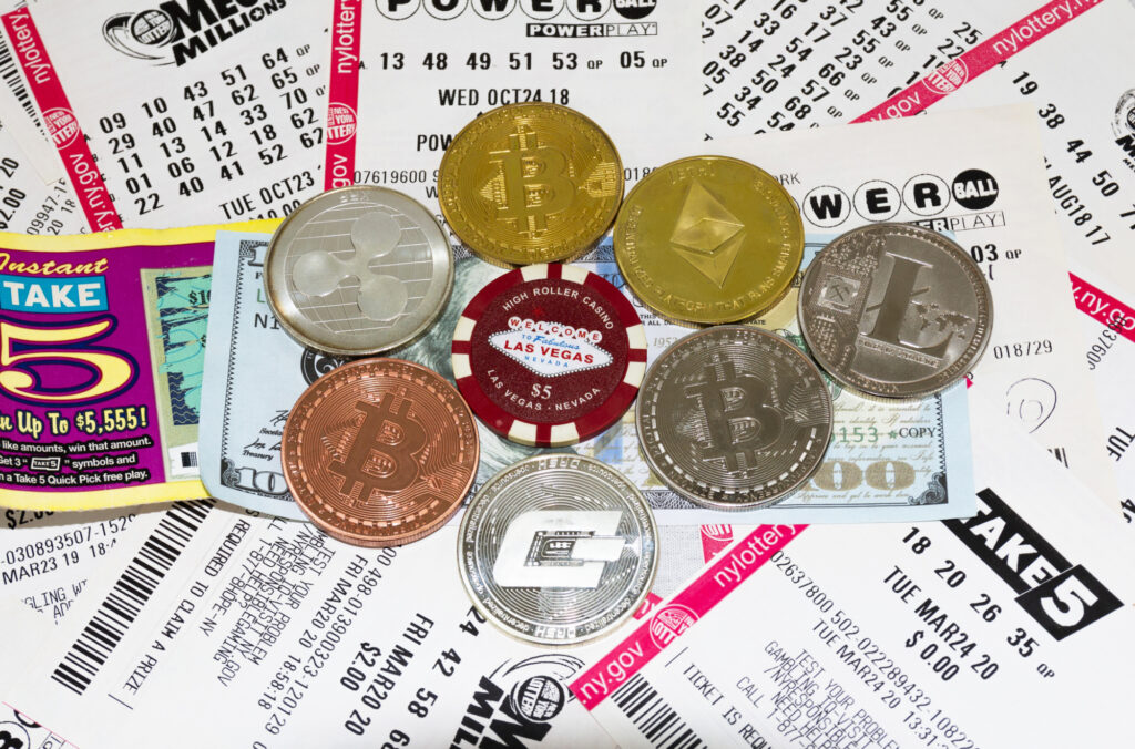 bitcoin ethereum and other cryptocurreny coins on top of lottery tickets and money 219344635