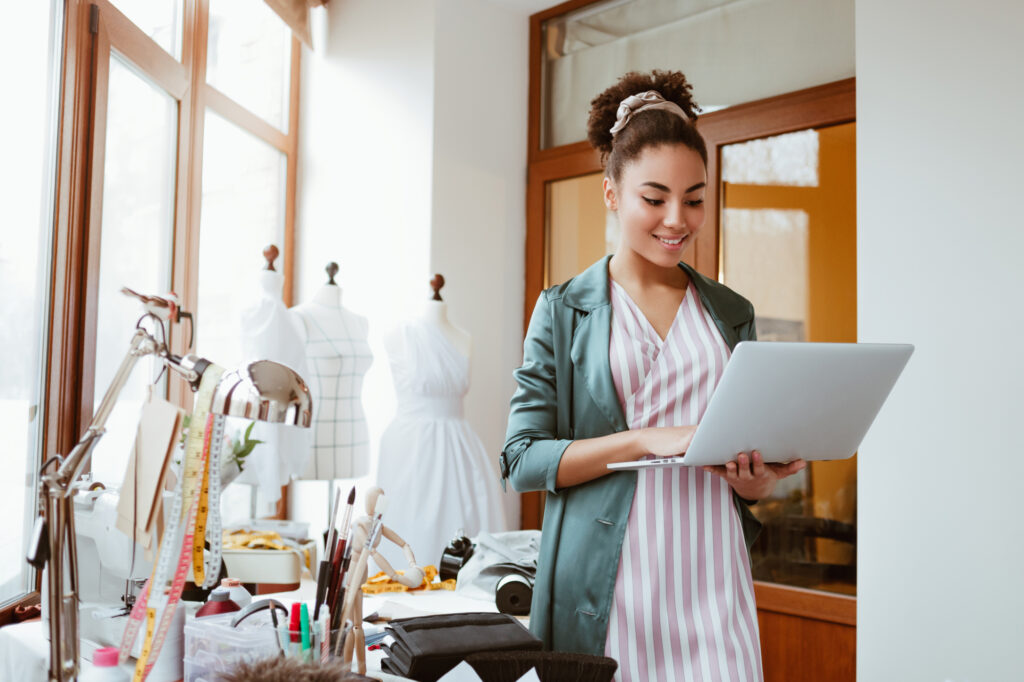 online orders by email young woman tailor with laptop is answering emails 138513948